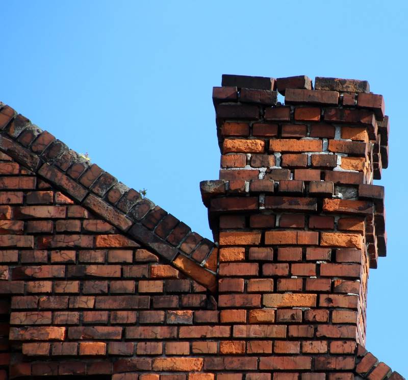 Damaged chimney on an Romeo home showing cracks and missing mortar